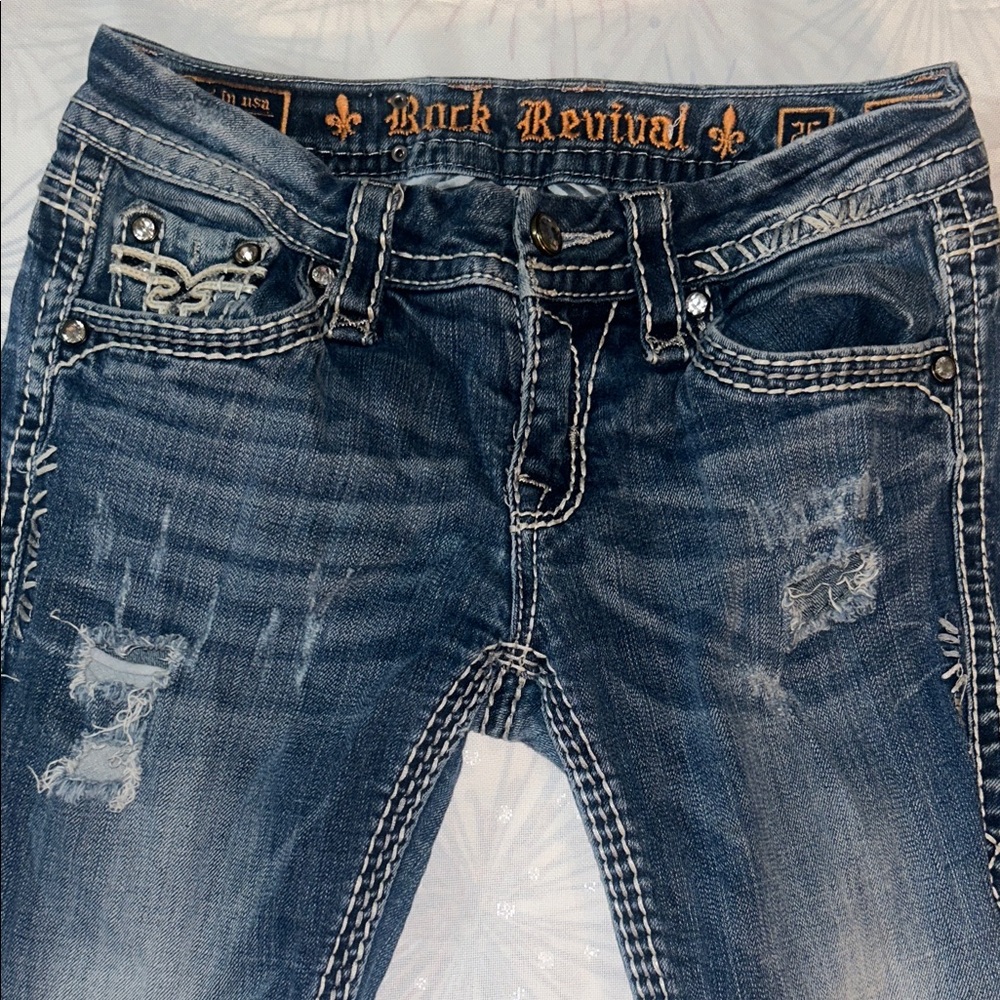 Rock Revival Blue Jeans with Distressed Wash and Contrast Stitching